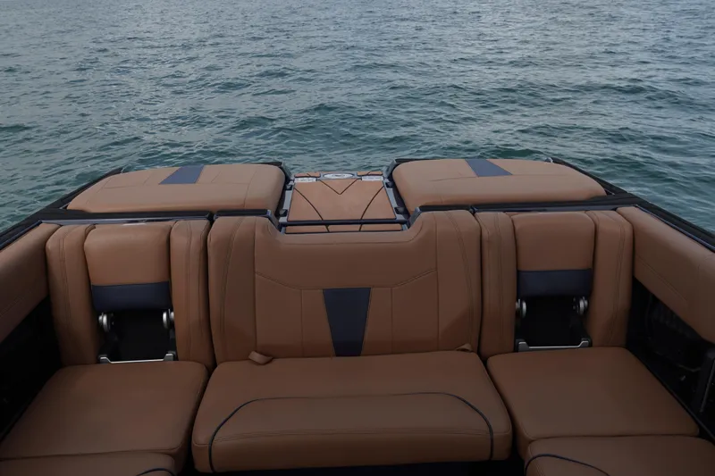 Slide: The Image of 2023 Malibu Wakesetter 23 LSV boat interior with tan seating on water. - 6