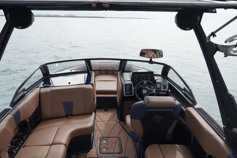 Slide: The Image of 2023 Malibu Wakesetter 23 LSV interior with luxurious seating and modern dashboard on the water. - 7