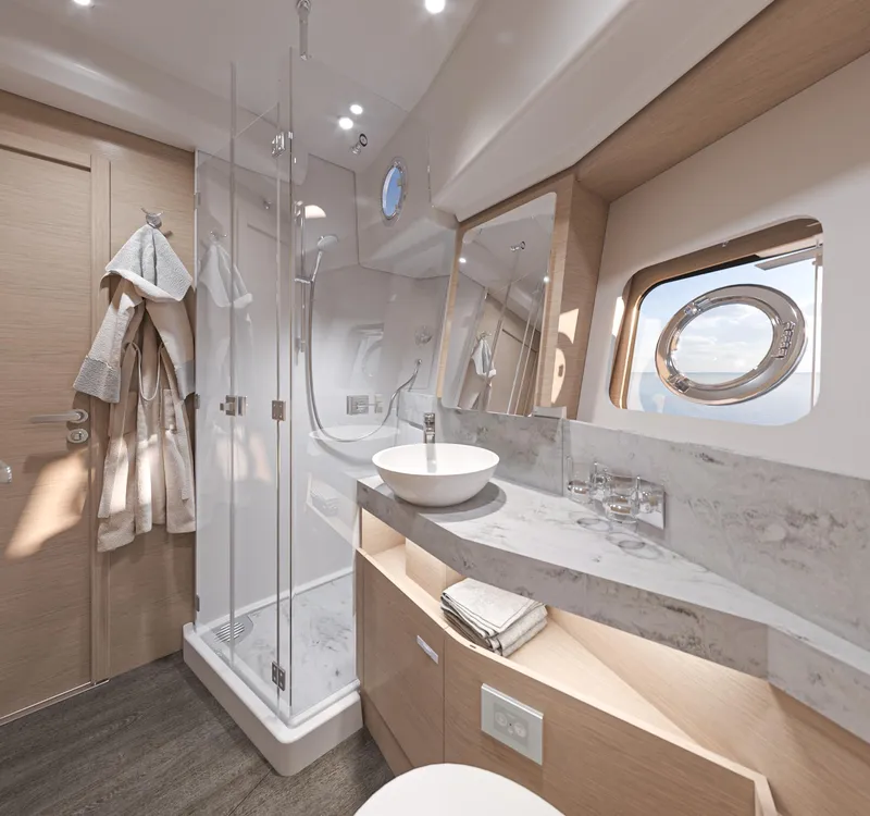 Slide: The Image of Luxurious bathroom in 2025 Beneteau Swift Trawler 54 with modern fixtures and porthole window. - 22
