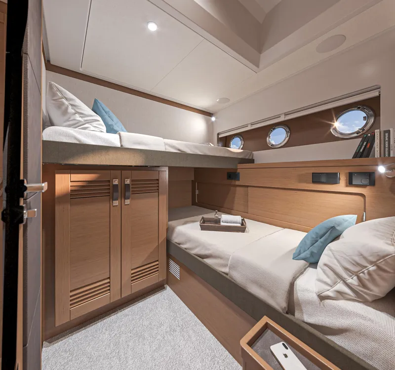 Slide: The Image of 2025 Beneteau Swift Trawler 54 cabin with bunk beds and modern wood finish. - 25