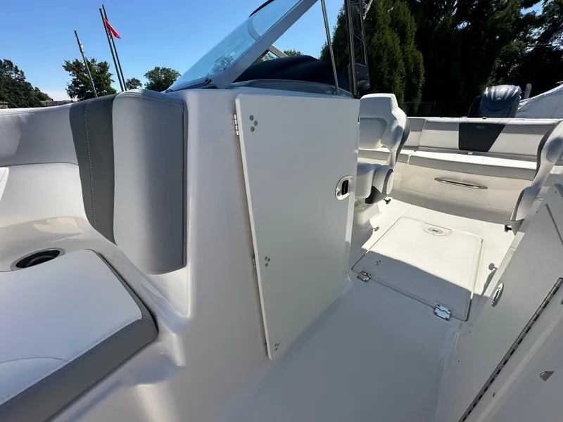 Slide: The Image of 2024 Chaparral 21 SSi OB boat interior, featuring seating and storage compartments. - 13