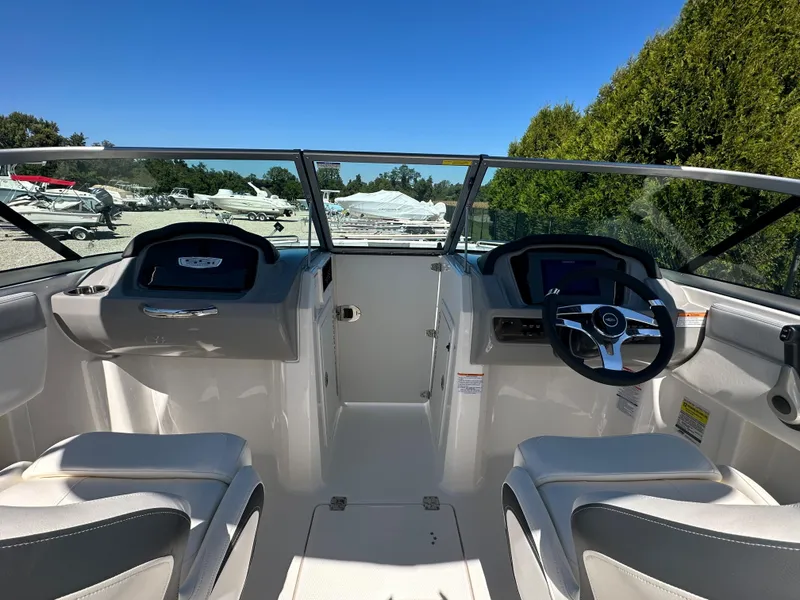 Slide: The Image of 2024 Chaparral 21 SSi OB boat interior with dual seating and steering console. - 14