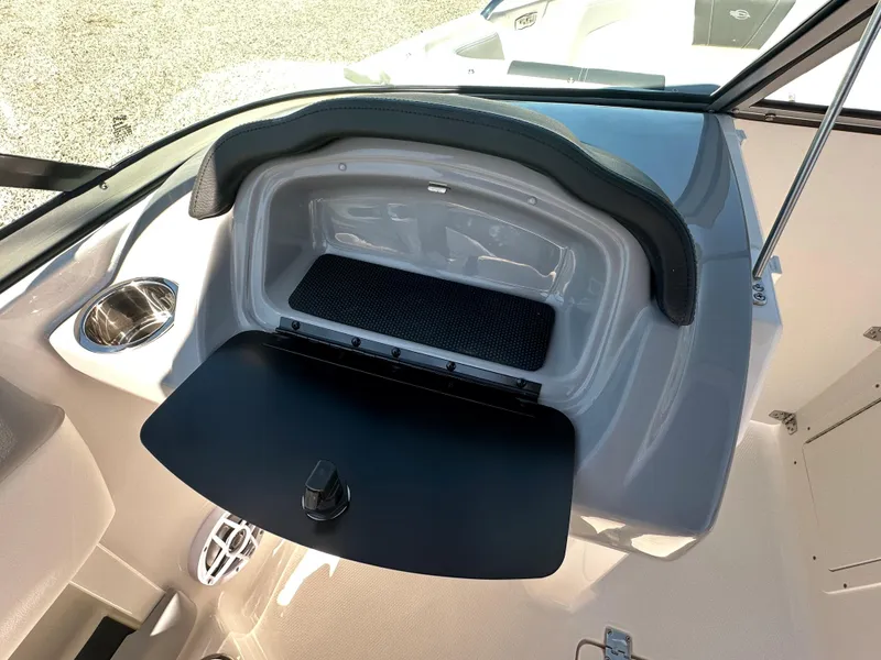 Slide: The Image of 2024 Chaparral 21 SSi OB boat dashboard storage compartment. - 18
