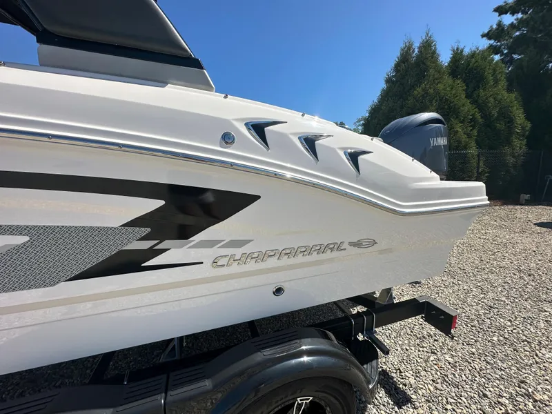 Slide: The Image of 2024 Chaparral 21 SSi OB boat side view with Yamaha outboard motor. - 2