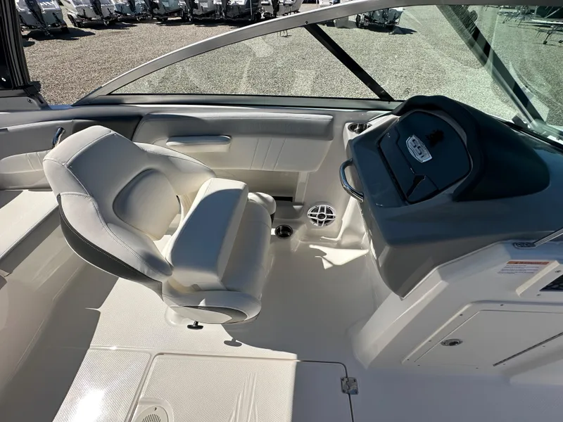 Slide: The Image of 2024 Chaparral 21 SSi OB boat interior with captain's seat and dashboard. - 21