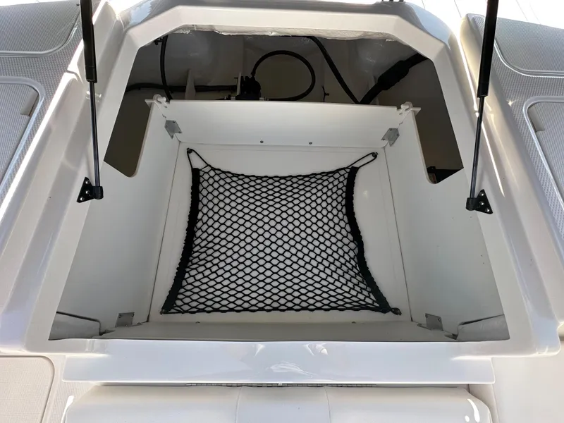 Slide: The Image of 2024 Chaparral 21 SSi OB boat storage compartment with netting. - 35
