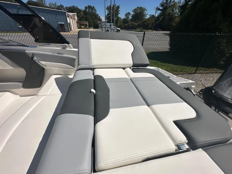 Slide: The Image of 2024 Chaparral 21 SSi OB boat with luxurious seating in a marina. - 42