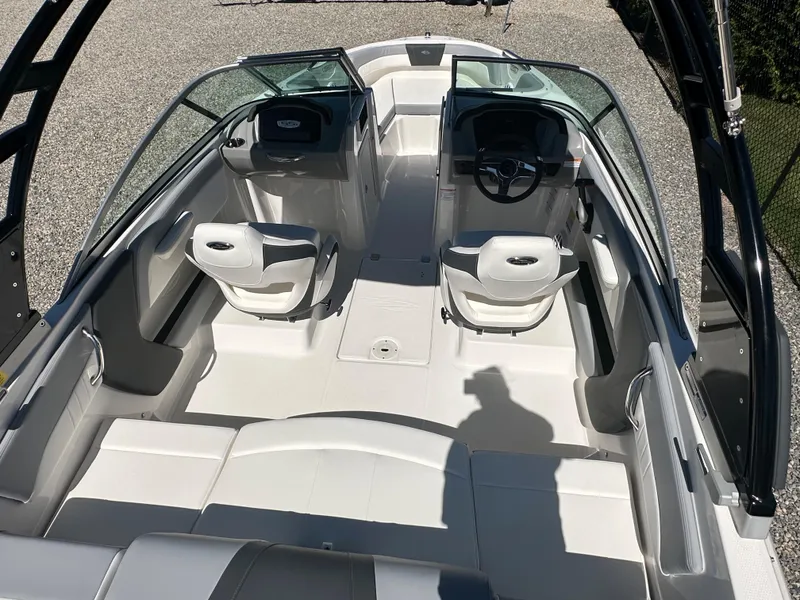 Slide: The Image of 2024 Chaparral 21 SSi OB boat interior with dual captain's chairs and spacious seating. - 44
