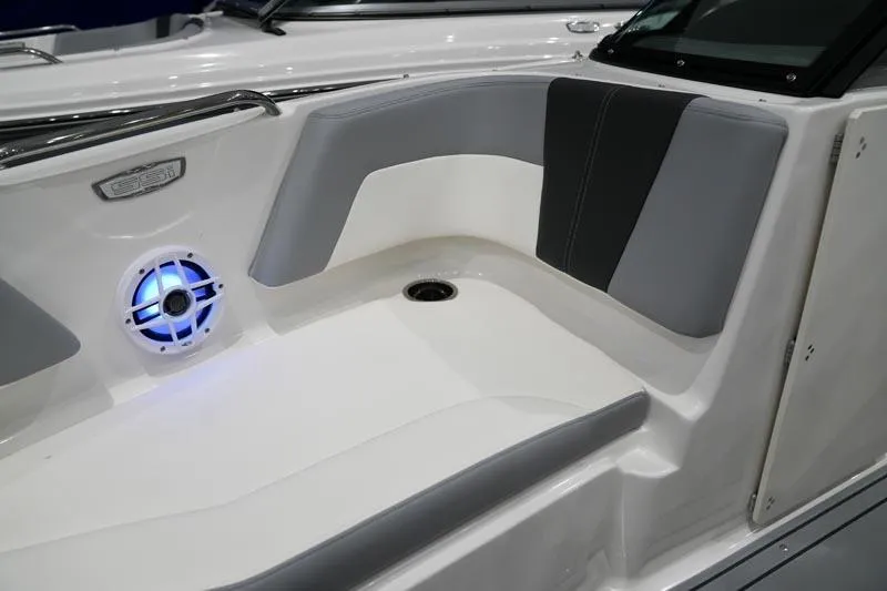 Slide: The Image of 2025 Chaparral 21 SSi boat interior with gray seating and blue LED speaker. - 11