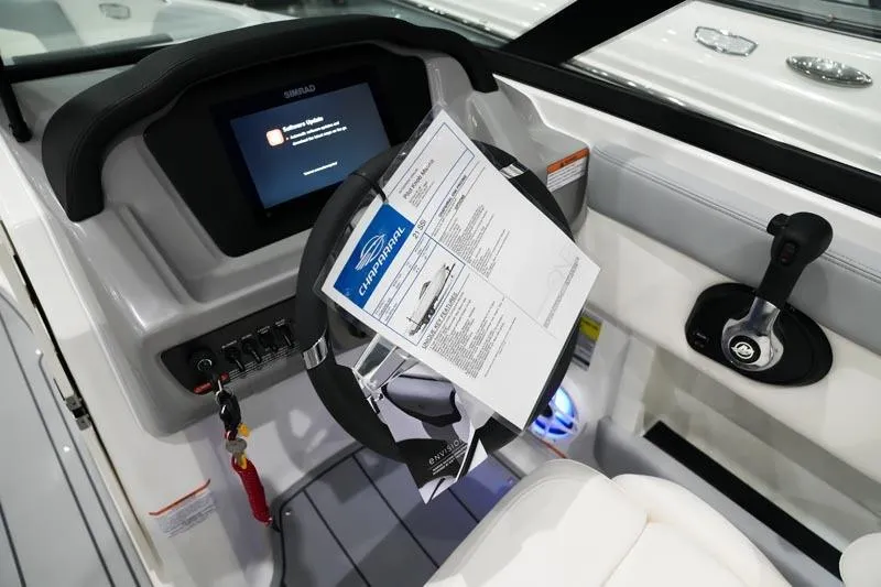 Slide: The Image of 2025 Chaparral 21 SSi boat dashboard with steering wheel and control panel. - 13
