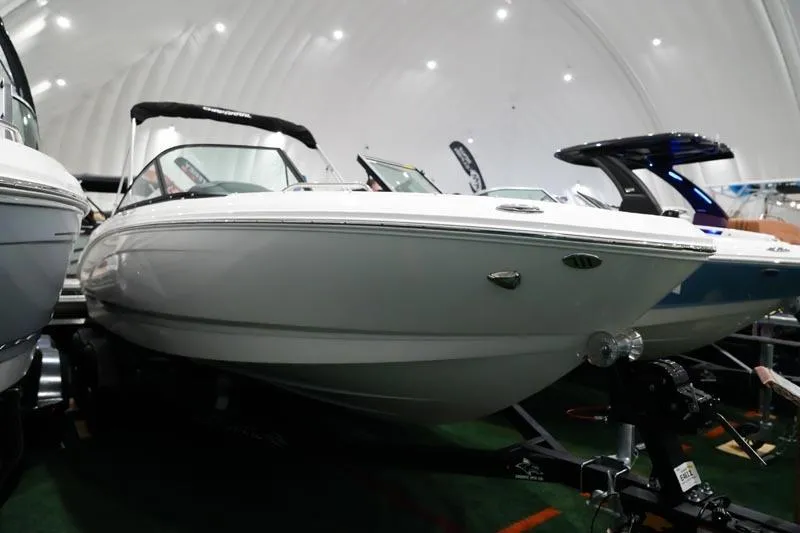 Slide: The Image of 2025 Chaparral 21 SSi boat displayed indoors, showcasing sleek design and modern features. - 15