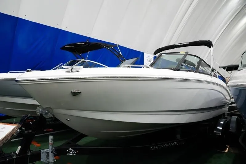 Slide: The Image of 2025 Chaparral 21 SSi boat displayed indoors with sleek design and modern features. - 16