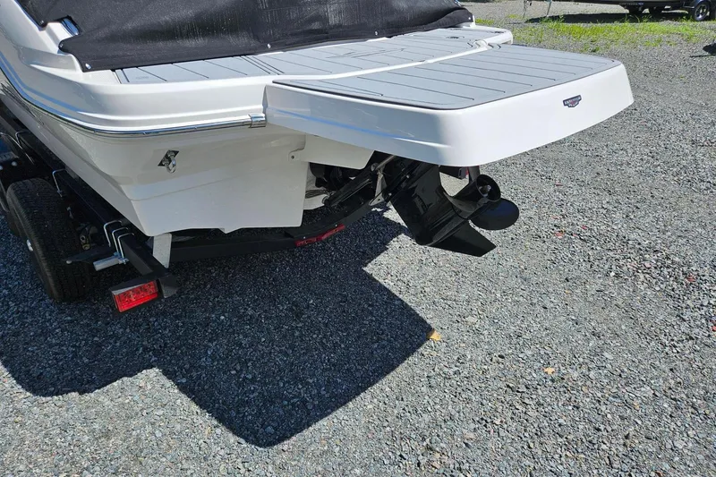Slide: The Image of 2025 Chaparral 21 SSi boat rear view with swim platform and outboard motor. - 17