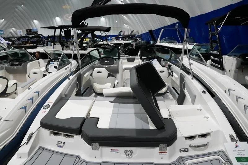 Slide: The Image of 2025 Chaparral 21 SSi boat interior at a showroom, featuring sleek seating and modern design. - 2