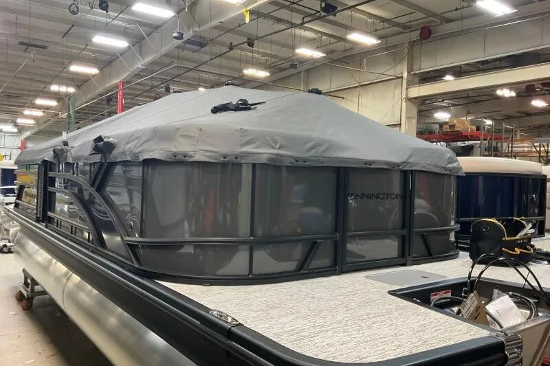 Slide: The Image of 2026 Bennington 22 SSRSE pontoon boat with cover in a warehouse setting. - 4