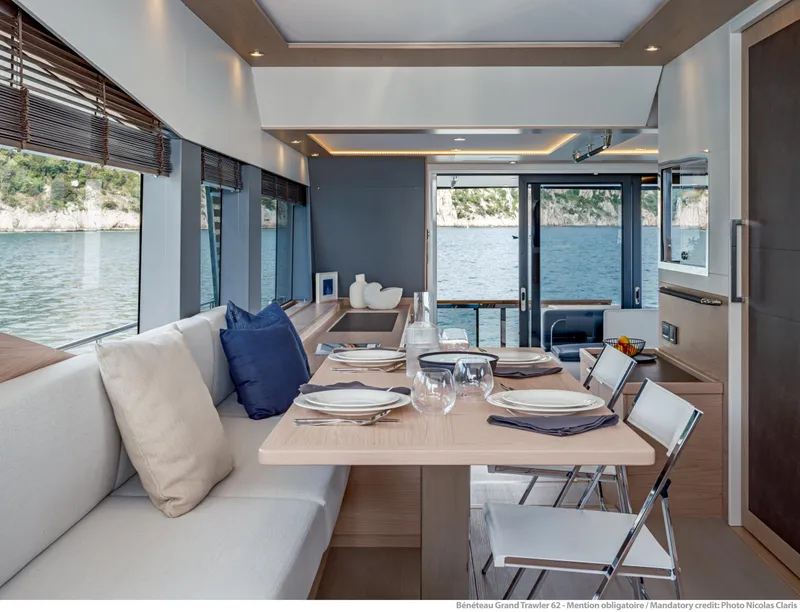 Slide: The Image of Luxurious interior of 2025 Beneteau Grand Trawler 62 with elegant dining area and scenic ocean view. - 31