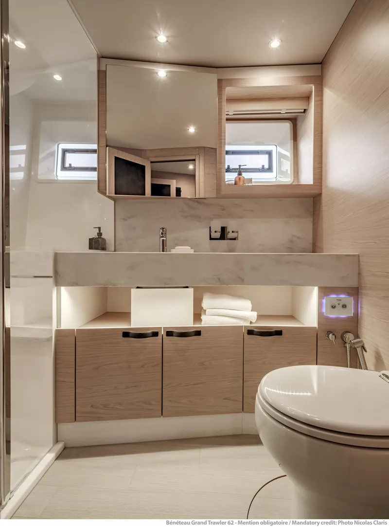 Slide: The Image of Luxurious bathroom in 2025 Beneteau Grand Trawler 62 yacht, featuring modern fixtures and elegant design. - 34