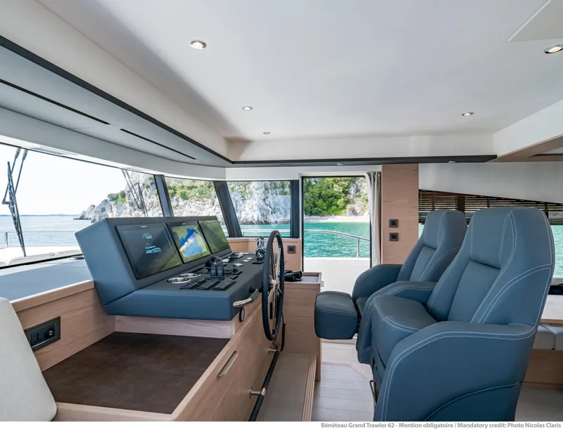 Slide: The Image of Interior of 2025 Beneteau Grand Trawler 62, featuring modern helm and ocean view. - 35