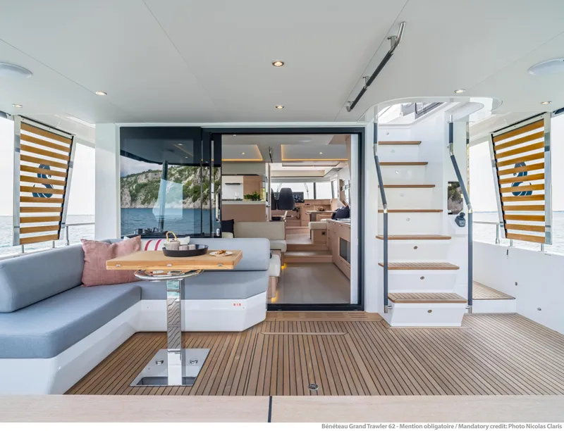 Slide: The Image of Luxurious 2025 Beneteau Grand Trawler 62 yacht interior with elegant seating and staircase. - 6