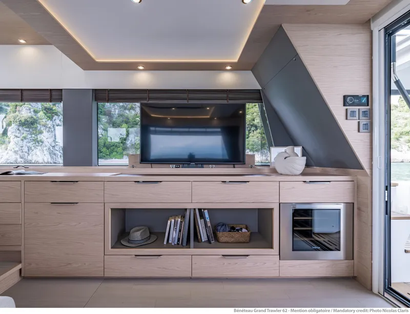 Slide: The Image of Luxurious interior of 2025 Beneteau Grand Trawler 62 with modern entertainment center. - 9
