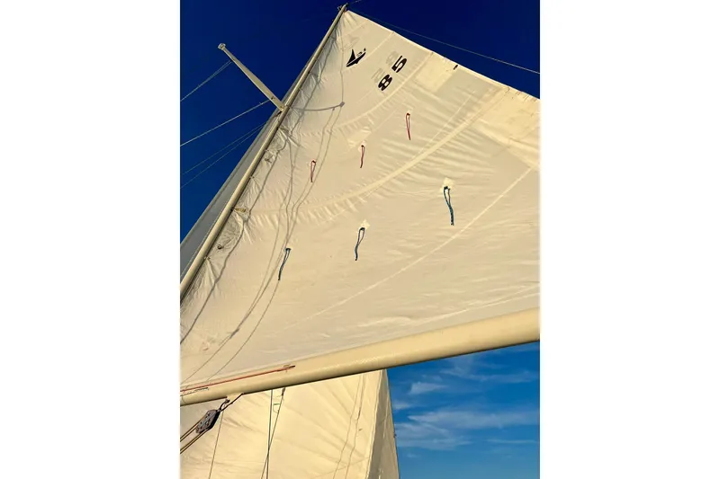 Slide: The Image of Sail of a 1994 Pacific Seacraft 31 against a clear blue sky. - 10