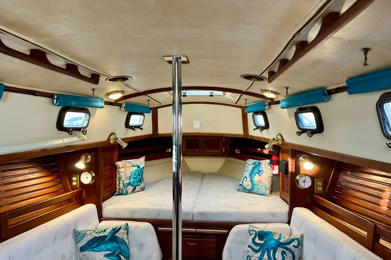 Slide: The Image of Cozy interior of 1994 Pacific Seacraft 31 sailboat with nautical decor and wood accents. - 14