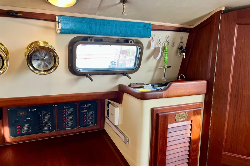 Slide: The Image of Interior of 1994 Pacific Seacraft 31 sailboat with navigation instruments and wooden cabinetry. - 17