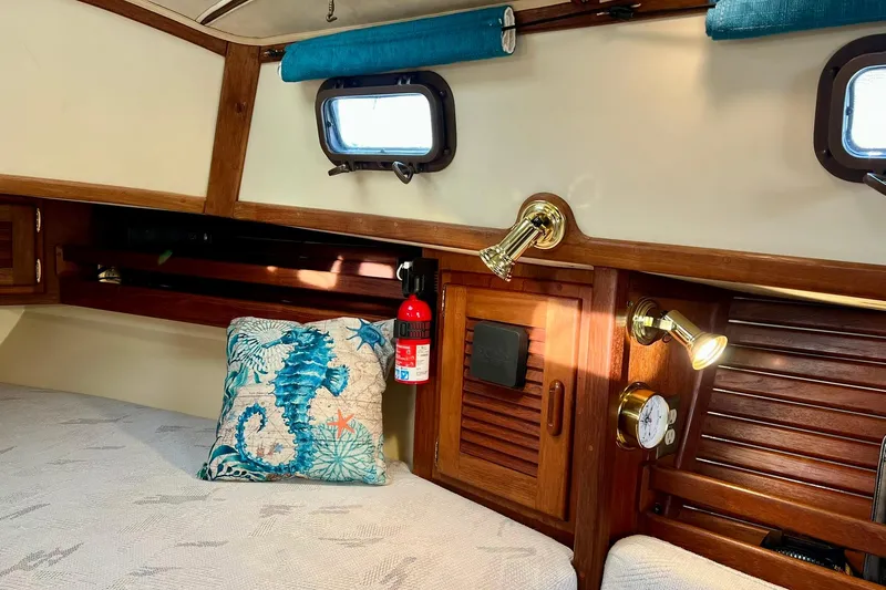 Slide: The Image of Cozy cabin interior of 1994 Pacific Seacraft 31 with nautical decor and wooden accents. - 19