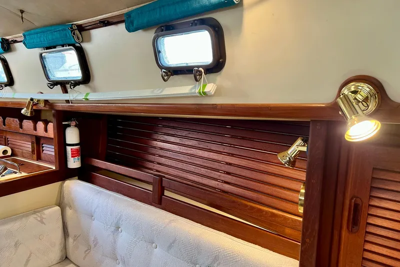 Slide: The Image of Interior of 1994 Pacific Seacraft 31 sailboat with wooden accents and brass lighting. - 20