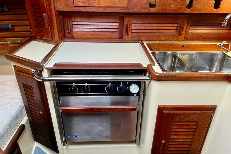 Slide: The Image of Galley kitchen in 1994 Pacific Seacraft 31 sailboat with stove and sink. - 28