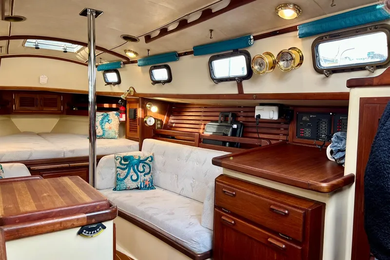 Slide: The Image of Interior of 1994 Pacific Seacraft 31 sailboat with cozy seating and nautical decor. - 31