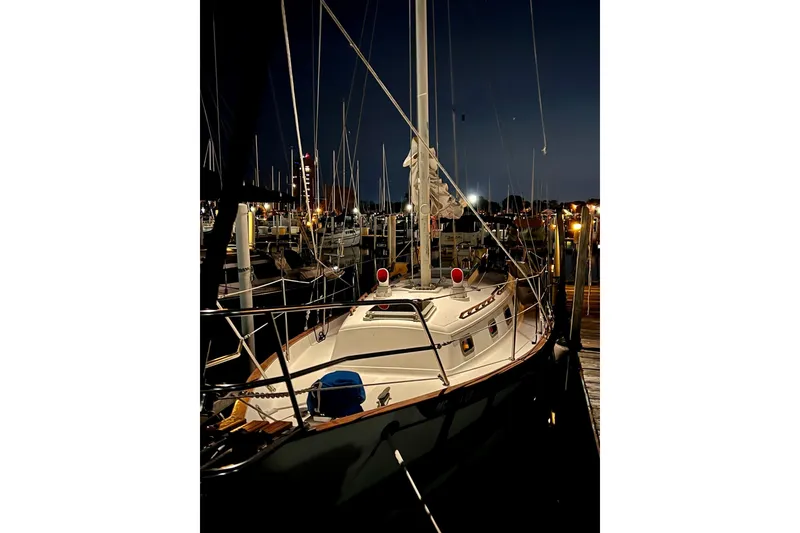 Slide: The Image of Sailboat docked at night, Pacific Seacraft 31, 1994 model, illuminated marina background. - 9