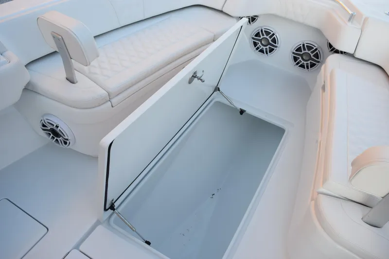 Slide: The Image of 2026 Contender 32 ST boat interior with open storage compartment and speakers. - 17