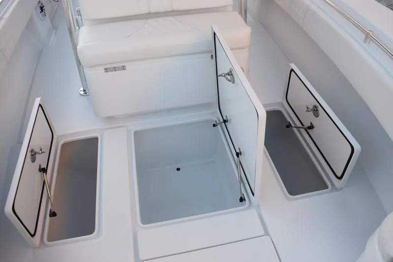 Slide: The Image of 2026 Contender 32 ST boat with open storage compartments and white seating. - 20