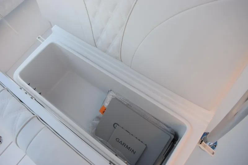 Slide: The Image of Storage compartment in 2026 Contender 32 ST boat with Garmin device inside. - 22
