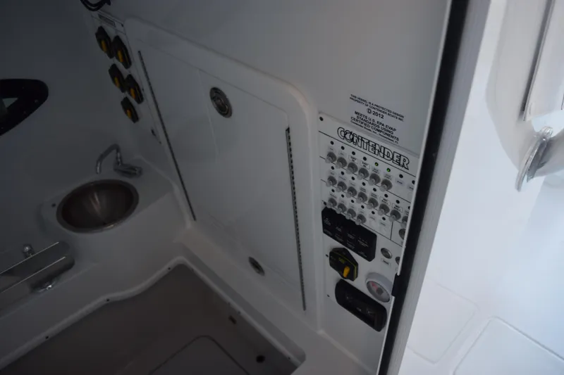 Slide: The Image of Interior view of 2026 Contender 32 ST boat control panel and sink area. - 24