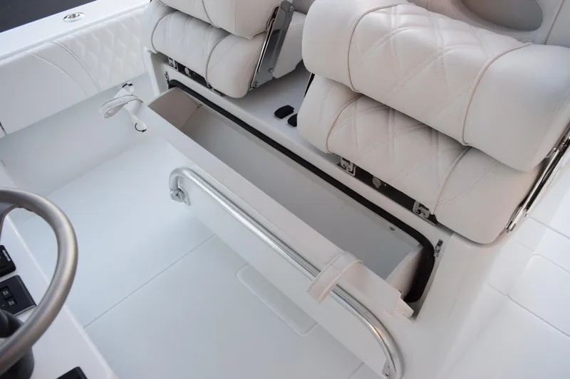 Slide: The Image of 2026 Contender 32 ST boat interior with white cushioned seating and storage compartment. - 27