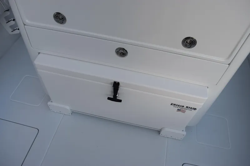 Slide: The Image of 2026 Contender 32 ST boat storage compartment with Frigid Rigid cooler. - 30