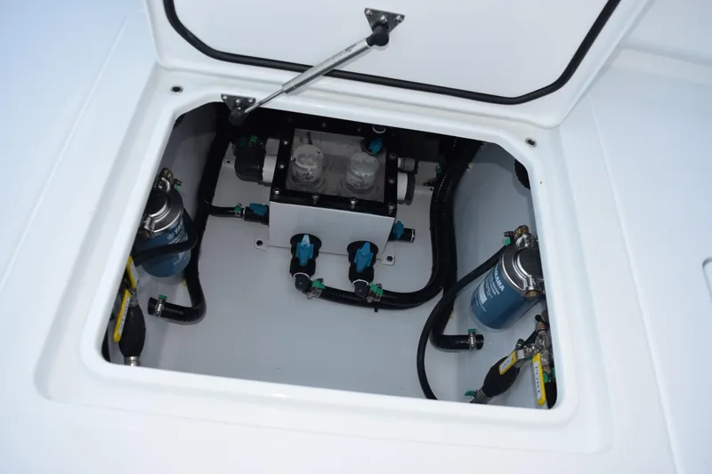 Slide: The Image of 2026 Contender 32 ST boat compartment with fuel filters and hoses. - 32