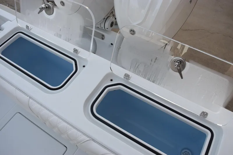 Slide: The Image of 2026 Contender 32 ST boat with dual livewells and clear lids. - 34