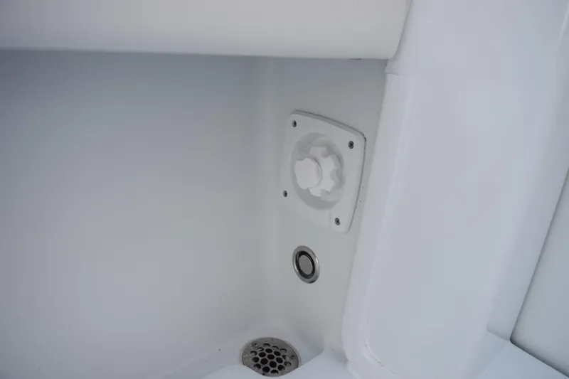 Slide: The Image of 2026 Contender 32 ST boat interior detail with drain and control knob. - 36