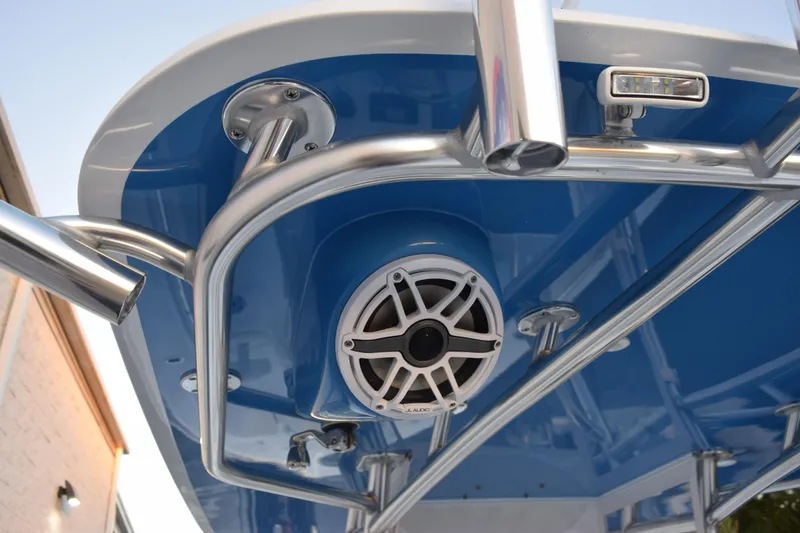 Slide: The Image of 2026 Contender 32 ST boat with blue canopy, stainless steel rails, and integrated speaker system. - 38