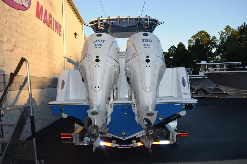 Slide: The Image of 2026 Contender 32 ST boat with dual 350 V6 engines at a marine dealership. - 5