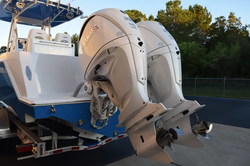 Slide: The Image of 2026 Contender 32 ST boat with dual Yamaha outboard engines, parked on a trailer. - 6