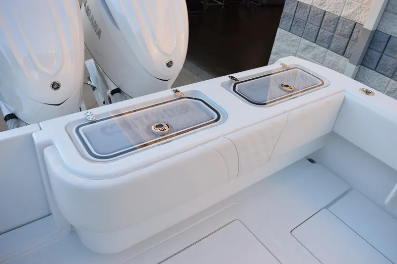 Slide: The Image of 2026 Contender 32 ST boat with dual Yamaha engines and sleek storage compartments. - 9