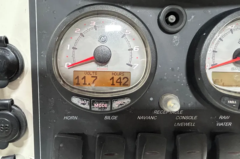Slide: The Image of Close-up of 2014 Boston Whaler 18 Dauntless dashboard gauges showing 11.7 volts and 142 hours. - 4