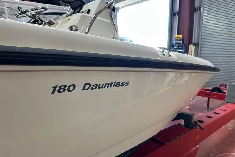 Slide: The Image of 2014 Boston Whaler 18 Dauntless boat in a garage setting. - 5