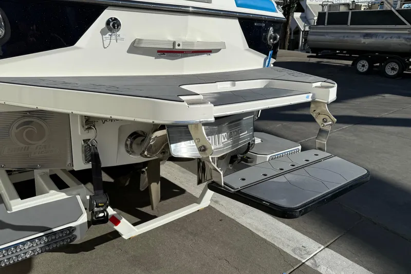 Slide: The Image of 2023 Malibu M240 boat with swim platform and surf gate technology. - 13