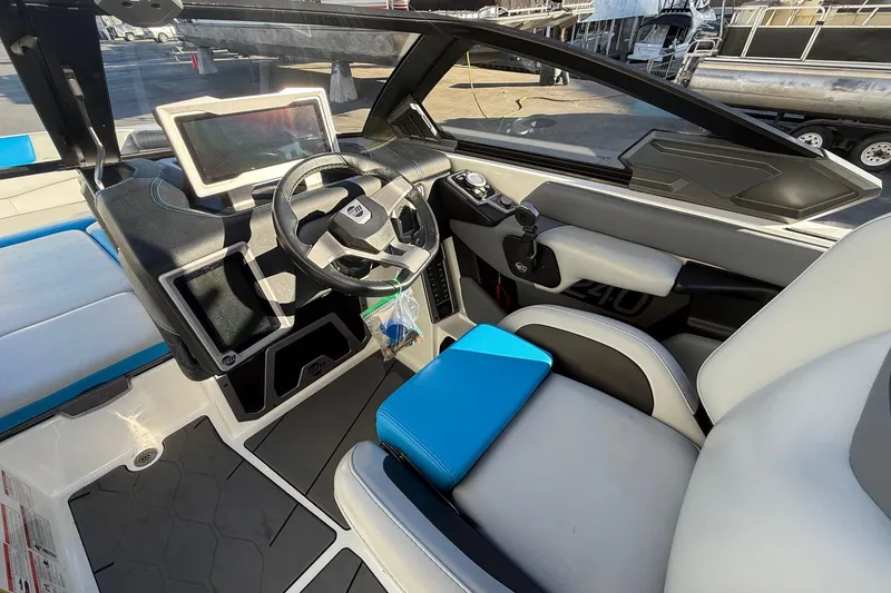 Slide: The Image of 2023 Malibu M240 boat interior with modern dashboard and steering wheel. - 18