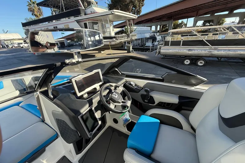 Slide: The Image of 2023 Malibu M240 boat interior with modern dashboard and steering wheel. - 19